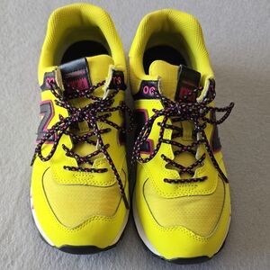 New Balance Yellow Athletic Shoes with Black and Pink Details